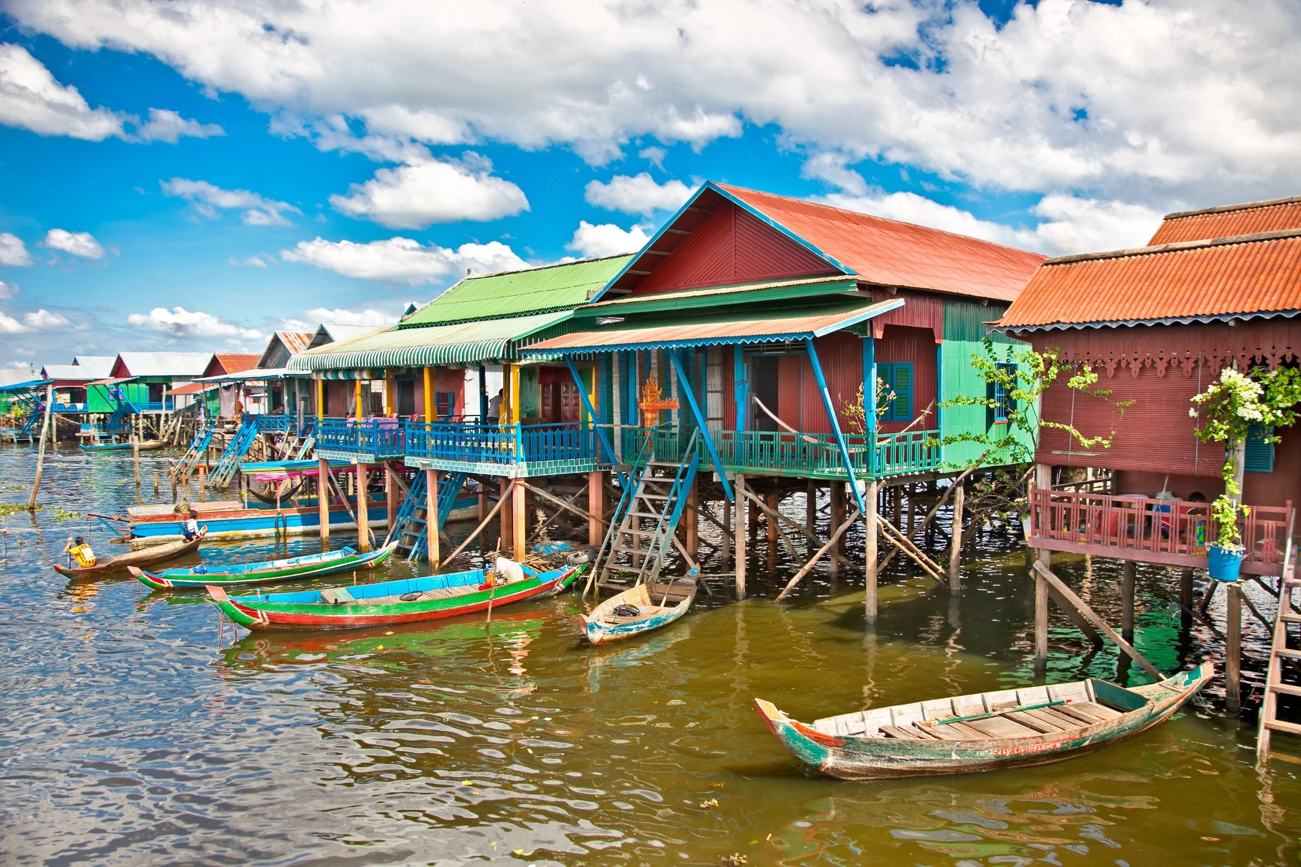 Colourful stilt houses and wooden boats at Kompong Phluk