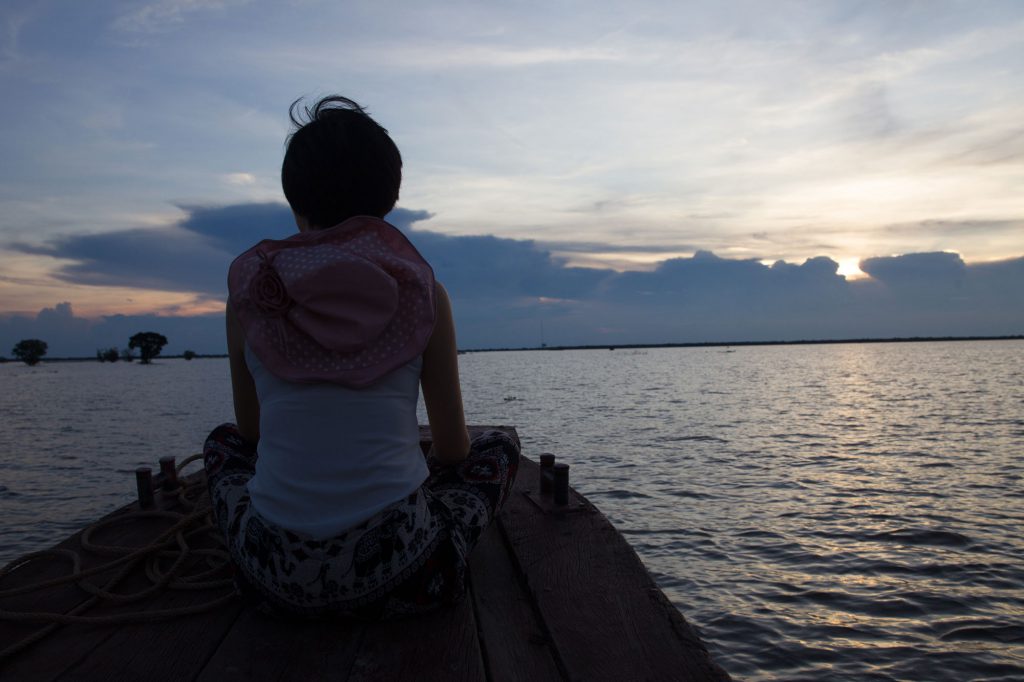 Tourist Watching Floating Village Sunset