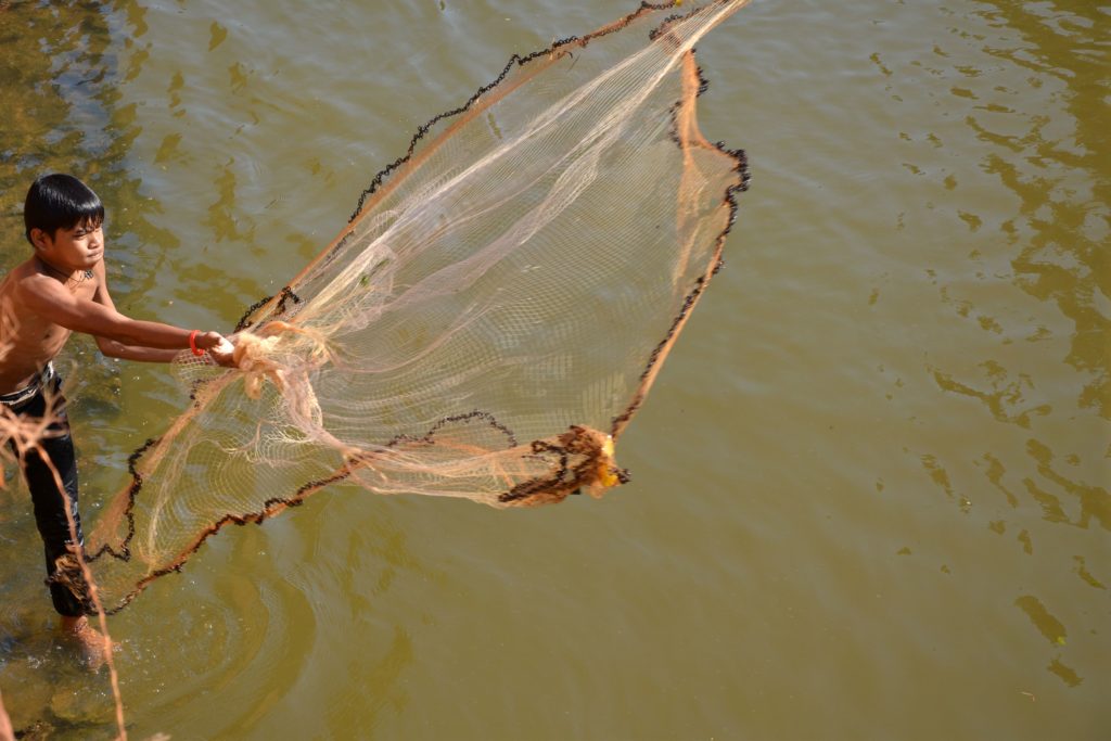 Child Casting Fishing Net